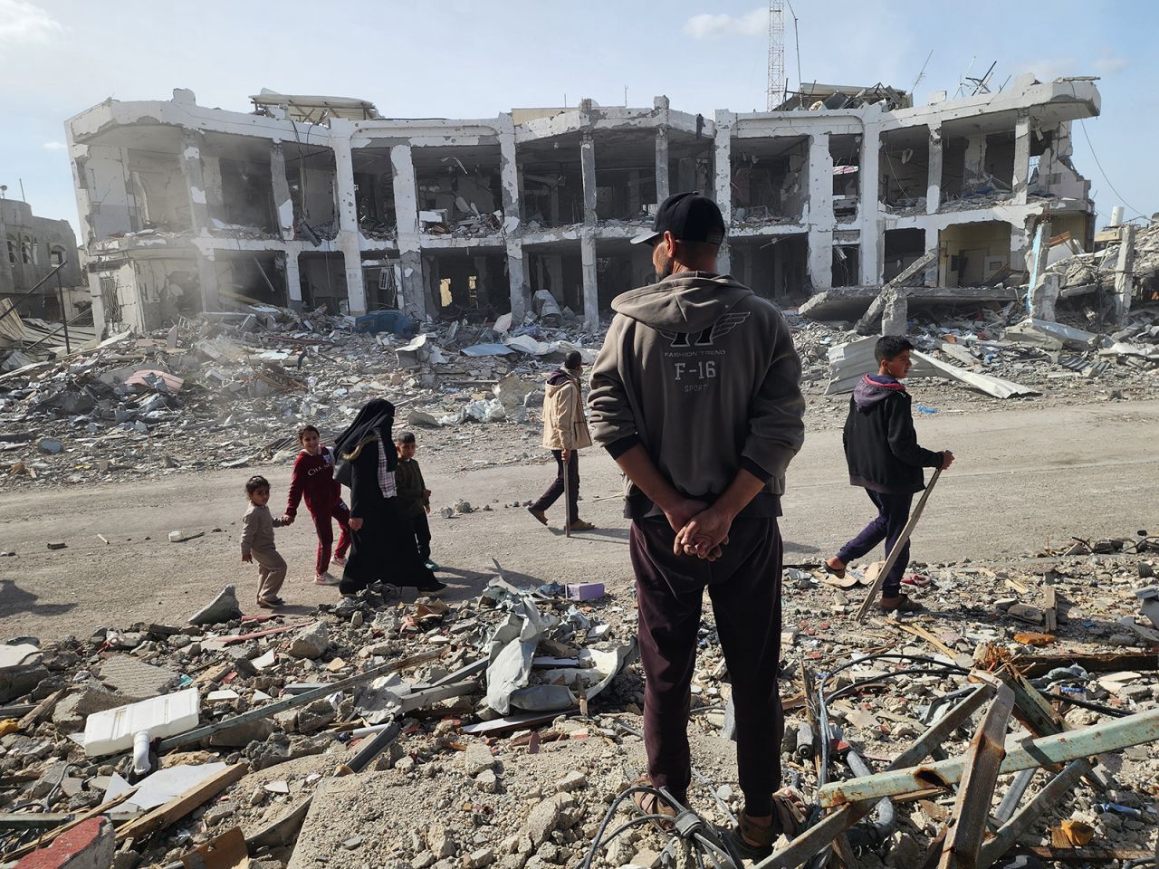 People walk past Abu Youssef Al-Najjar Hospital, damaged during Israeli attacks, in Rafah on Sunday.