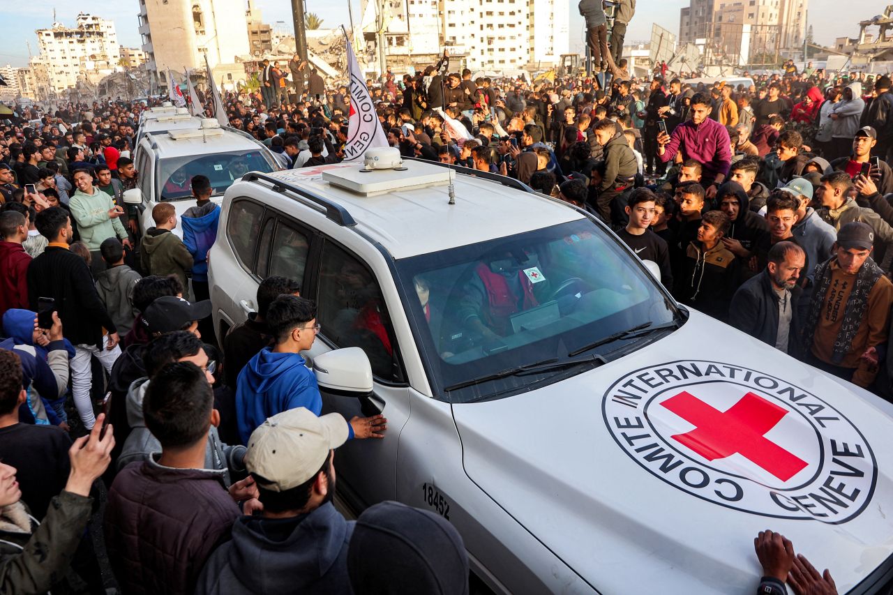 People gather around Red Cross vehicles in Gaza City on Sunday.