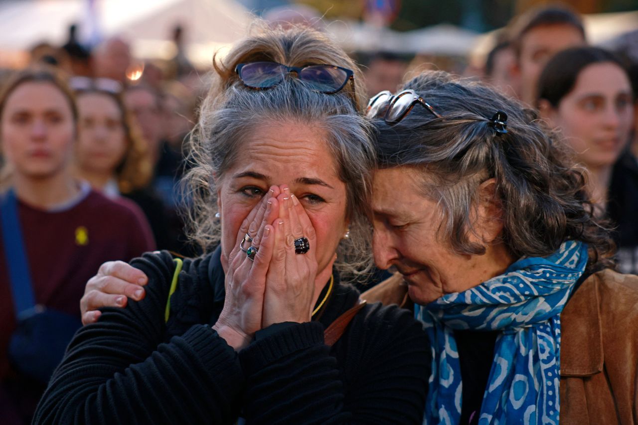 People react to watching a live television broadcast in Tel Aviv, Israel, showing the release of Israeli hostages on Sunday.