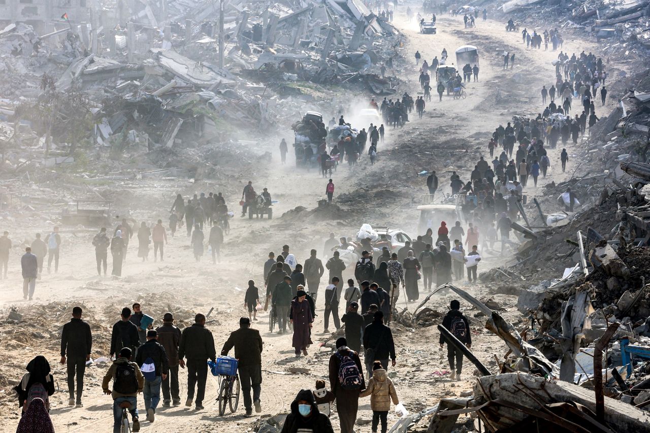 People walk past the rubble of collapsed buildings along Saftawi street in Jabalya in the northern Gaza Strip on January 20.