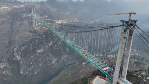 QIANXINAN, CHINA - JANUARY 17: Aerial view of the Huajiang Grand Canyon Bridge on January 17, 2025 in Zhenfeng County, Qianxinan Buyei and Miao Autonomous Prefecture, Guizhou Province of China. China on January 17 finished the construction of the main structure of the Huajiang Grand Canyon Bridge in its southwestern Guizhou Province, which is set to become the world's tallest bridge. A project of Guizhou Transportation Investment Group Co., Ltd., the suspension bridge has a vertical height of 625 meters from the bridge deck down to the river surface. The 2,890-meter bridge, with a span of 1,420 meters, is also the world's largest span bridge to be built in a mountainous area. (Photo by Qu Honglun/China News Service/VCG via Getty Images)