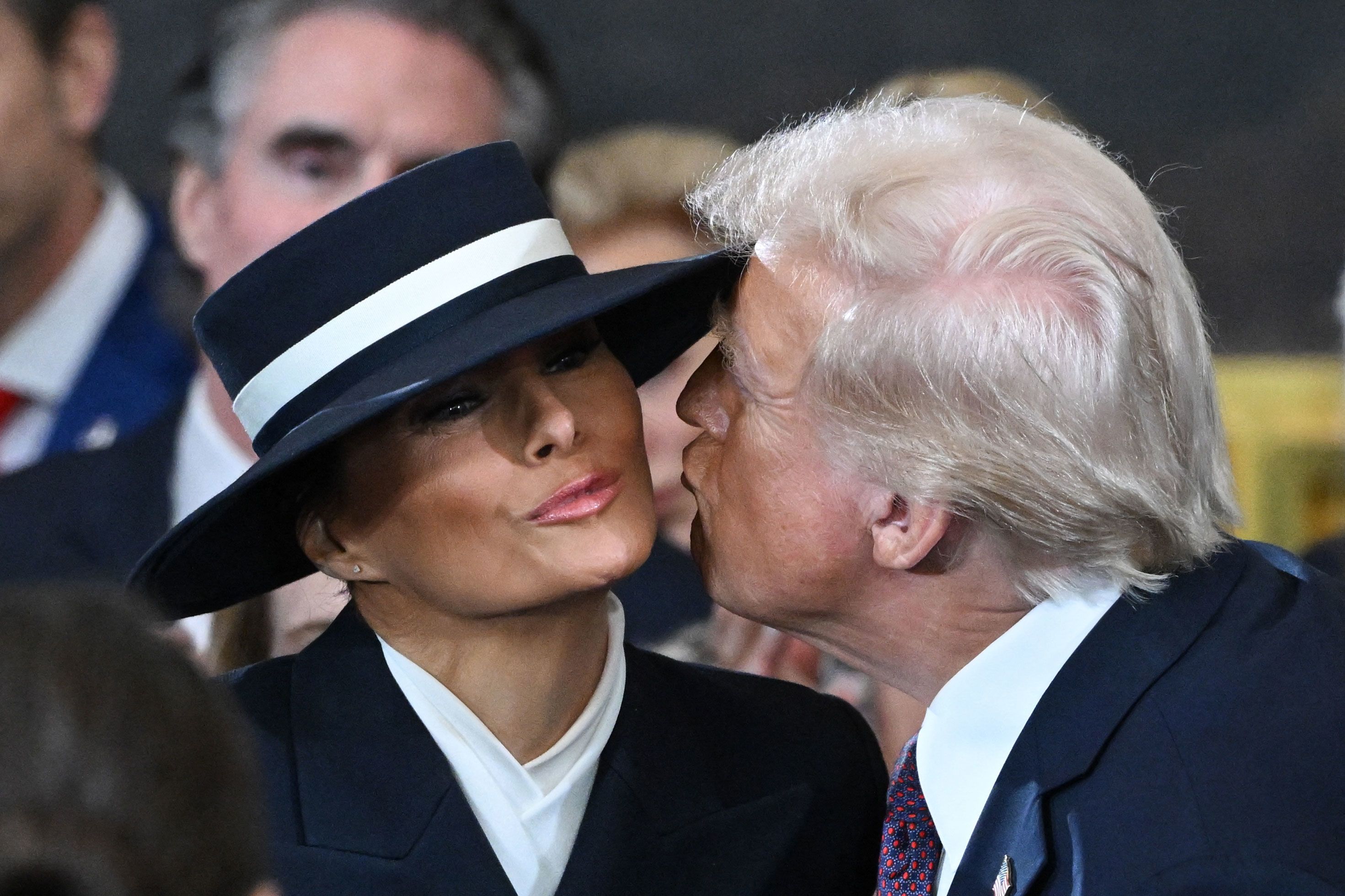 Trump attempts to kiss Melania as he arrives in the Capitol Rotunda for the inauguration ceremony on Monday.