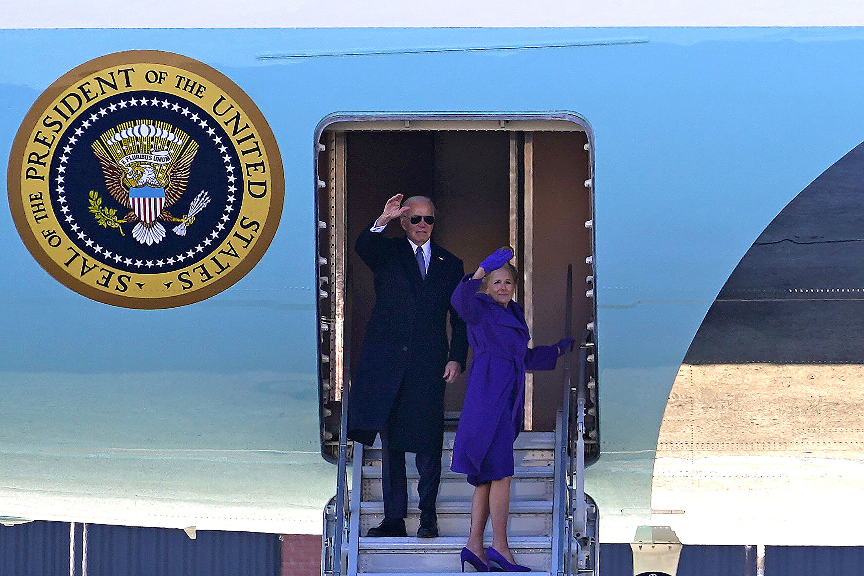 Former President Biden and former first lady Jill Biden wave as they board Air Force One at Joint Base Andrews in Maryland during a farewell ceremony on Monday.