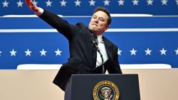 TOPSHOT - Tesla and SpaceX CEO Elon Musk gestures as he speaks during the inaugural parade inside Capitol One Arena, in Washington, DC, on January 20, 2025. (Photo by ANGELA WEISS / AFP) (Photo by ANGELA WEISS/AFP via Getty Images)