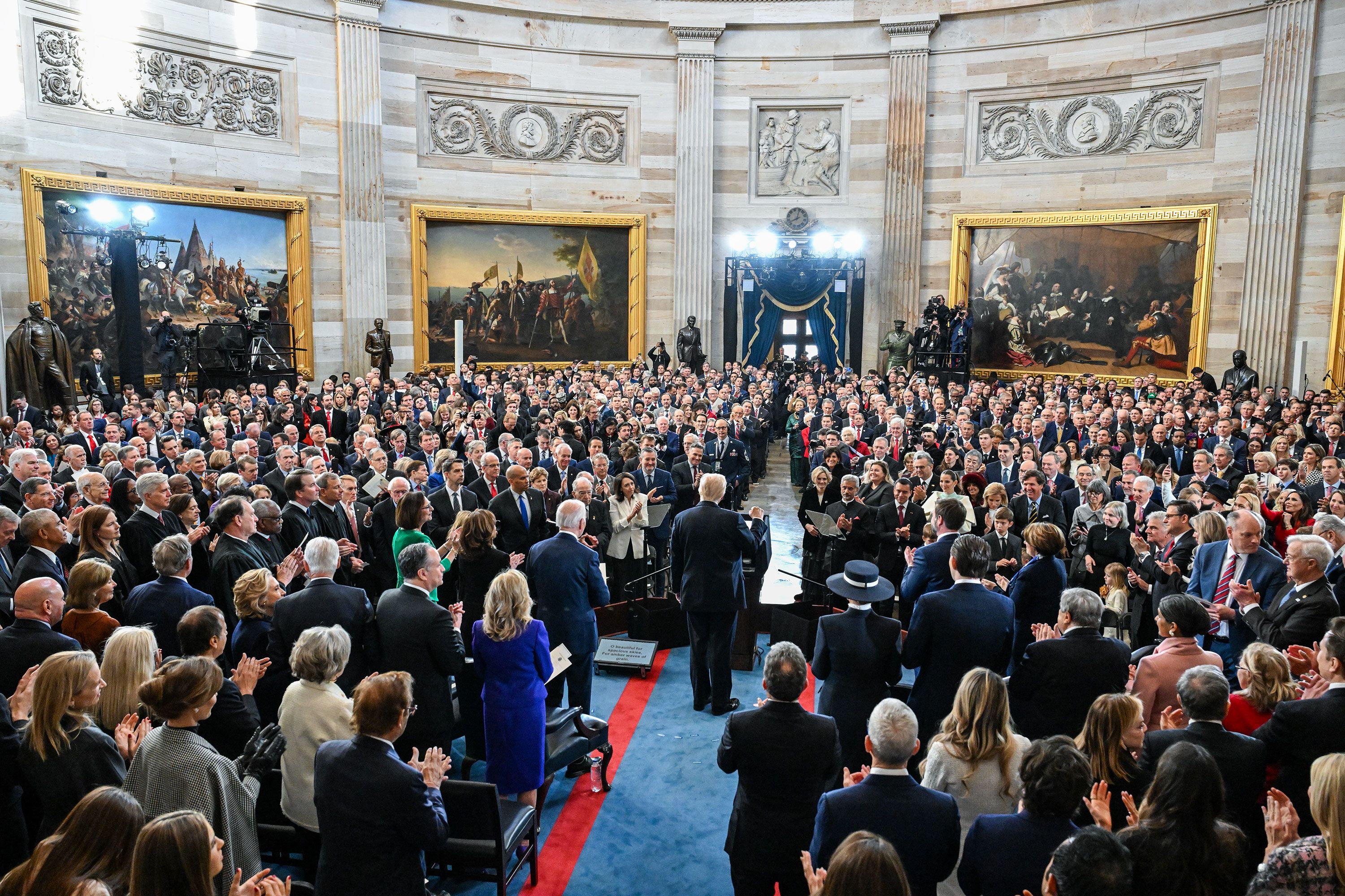 People applaud Trump during his inauguration on Monday.