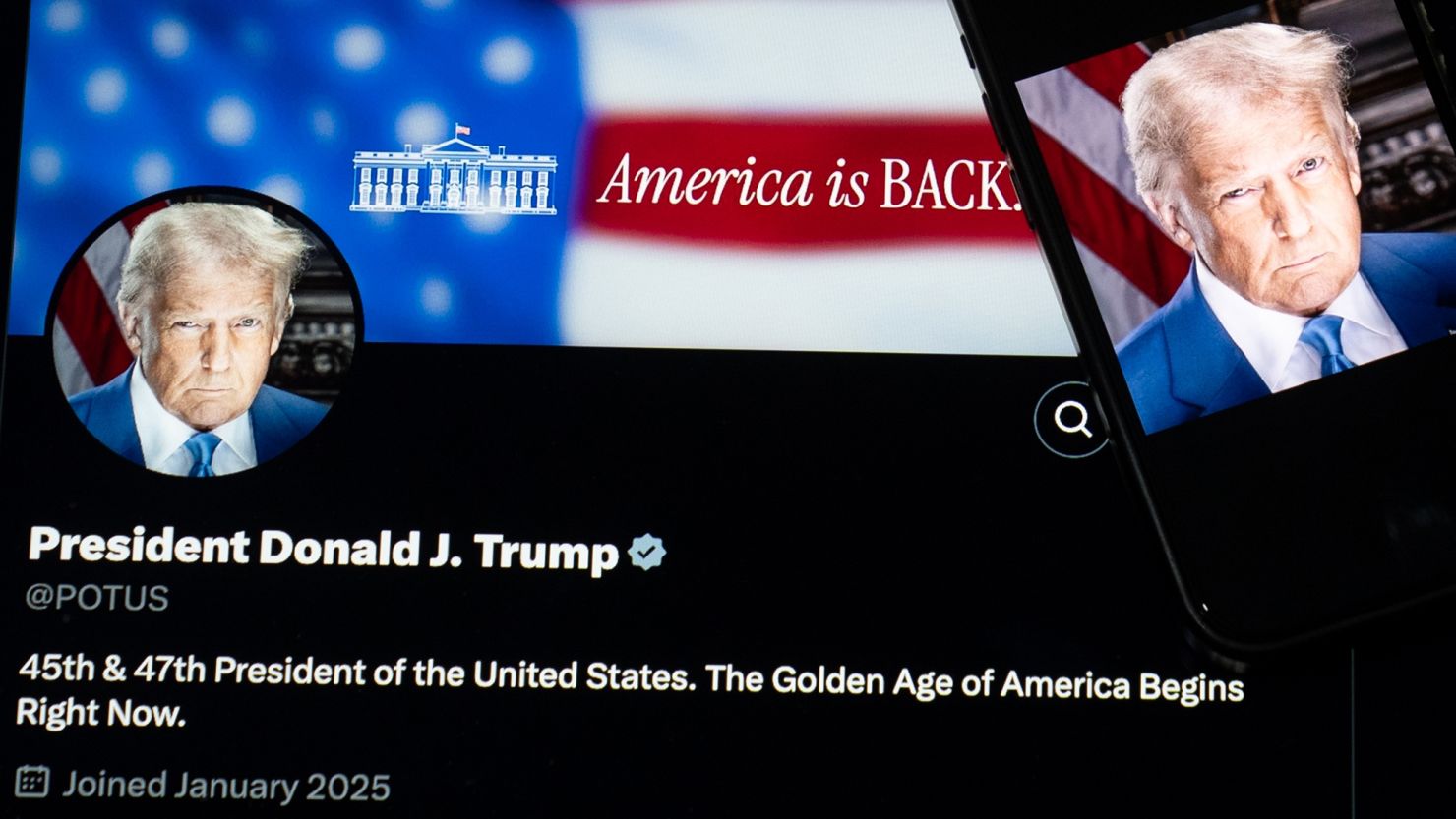 US President Donald Trump's photo and X account are displayed on digital screens.