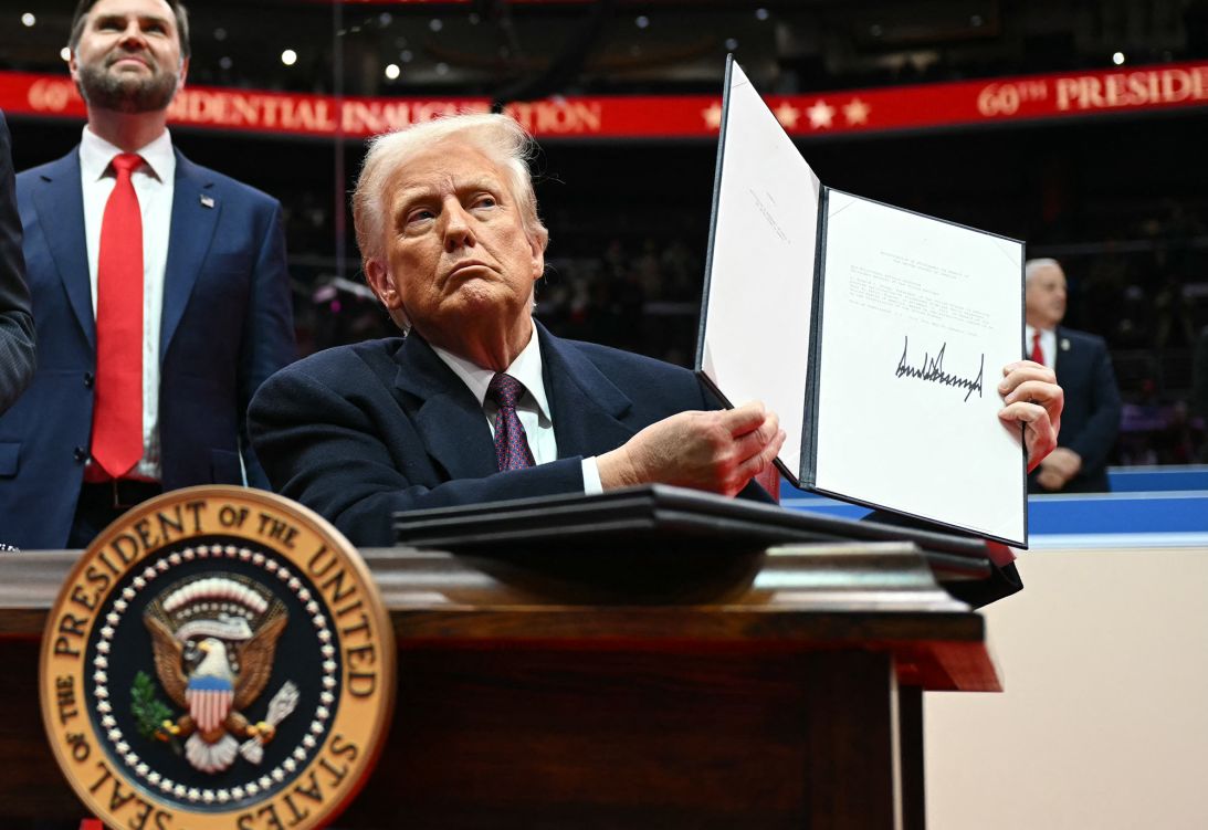 US President Donald Trump holds a letter to the UN stating the US will withdraw from the Paris climate agreement, on January 20, 2025.