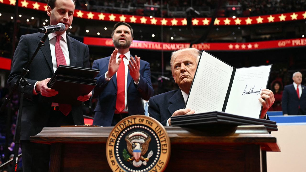 US President Donald Trump holds an executive order announcing the US withdrawal from the Paris Agreement, he just signed during the inaugural parade inside Capital One Arena, in Washington, DC, on January 20, 2025. (Photo by Jim WATSON / AFP) (Photo by JIM WATSON/AFP via Getty Images)