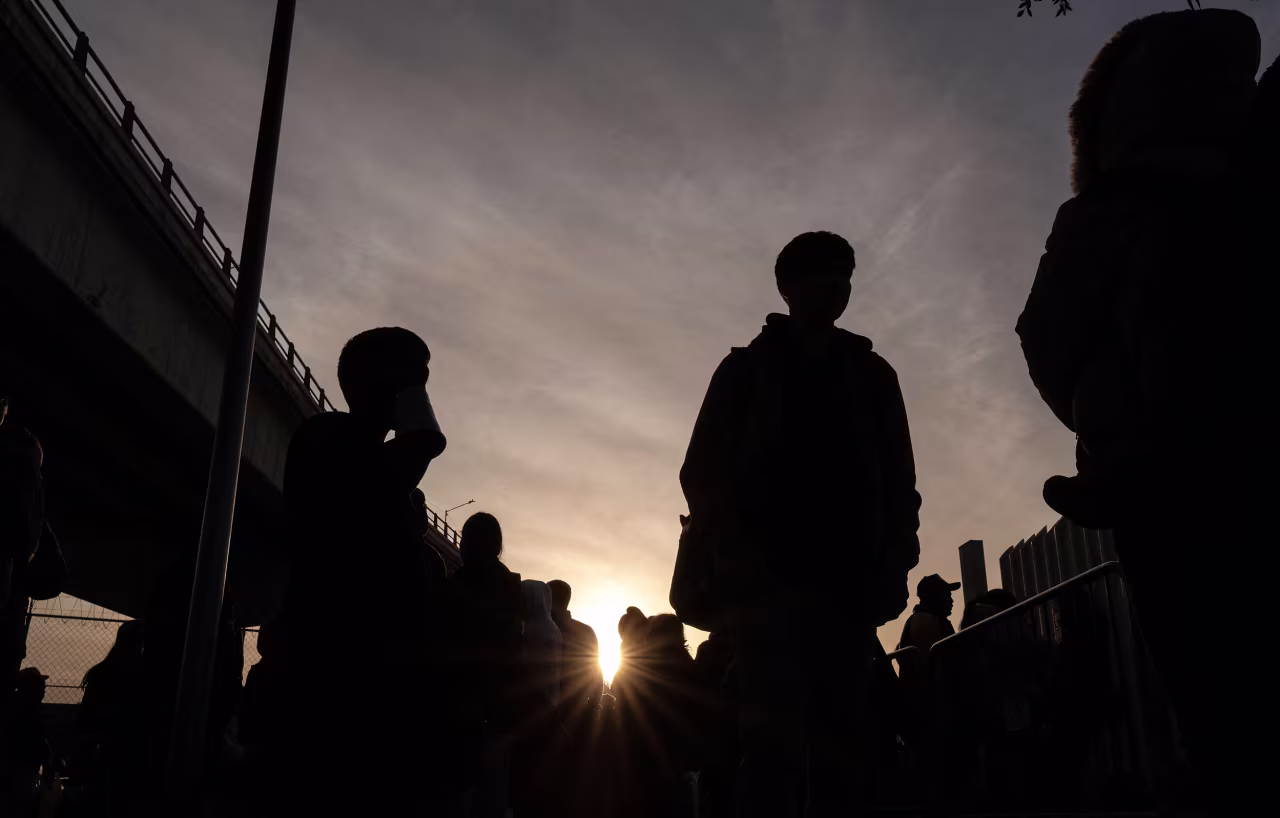 Asylum seekers wait at the El Chaparral port in Tijuana, Baja California state, Mexico, on January 20.