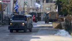 Israeli forces in armoured vehicles conduct a raid in Jenin in the occupied West Bank on January 21, 2025. (Photo by JAAFAR ASHTIYEH / AFP) (Photo by JAAFAR ASHTIYEH/AFP via Getty Images)