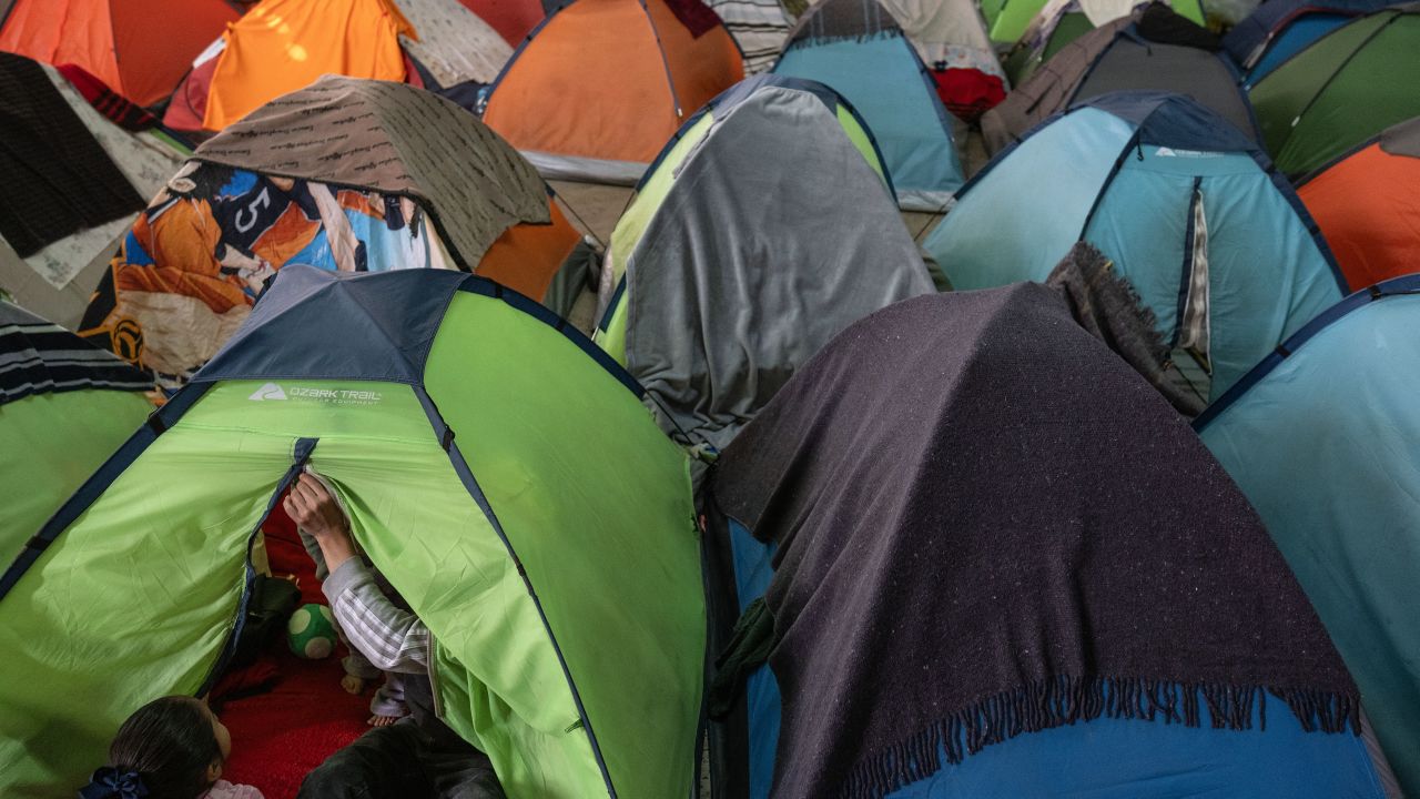 An asylum seeker sits on the tent he occupies at Juventud 2000 migrant shelter in Tijuana, Baja California state, Mexico, on January 21, 2025. Mexico will offer humanitarian protection to migrants that the United States deports to its territory, President Claudia Sheinbaum said Tuesday, after her counterpart Donald Trump announced an all-out war against illegal migration. (Photo by Guillermo Arias / AFP) (Photo by GUILLERMO ARIAS/AFP via Getty Images)