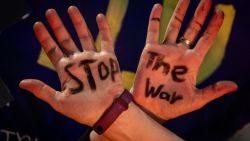 TEL AVIV - JANUARY 18: A woman shows off a stop war slogan written on her hands during an anti-government protest calling for action to secure the release of Israeli hostages, a day before a ceasefire is expected to take effect on January 18, 2025 in Tel Aviv, Israel. A ceasefire deal between Israel and Hamas is expected to take effect on Sunday morning, with the release of the first hostages later that day. A total of 33 hostages held in Gaza are expected to be released during the first phase of the ceasefire, in exchange for 1,890 Palestinian prisoners held by Israel.  (Photo by Chris McGrath/Getty Images)