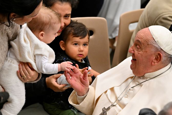 The Pope blesses a baby during his weekly general audience at the Vatican in January 2025.