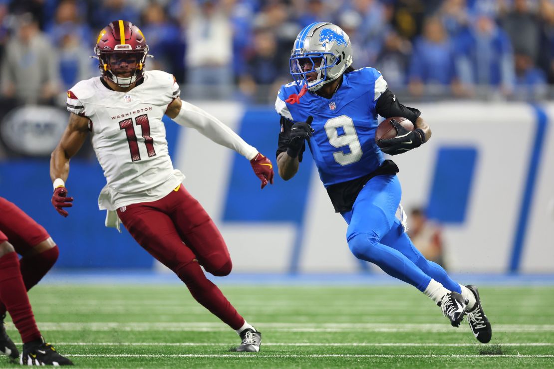 Jameson Williams #9 of the Detroit Lions runs the ball for a touchdown in the second quarter against the Washington Commanders in the NFC Divisional Playoff.