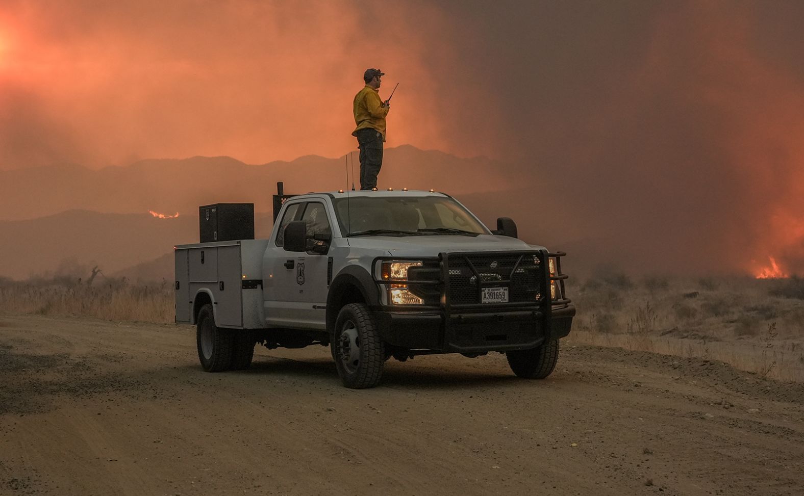 A US Forest Service firefighter surveys the Hughes Fire.