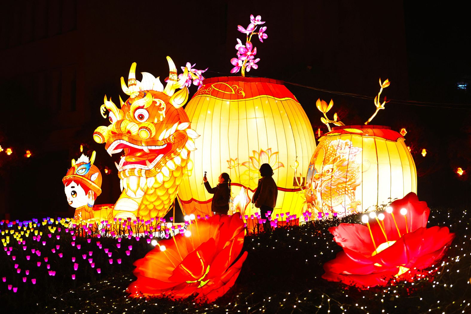 People look at a dragon-shaped lantern at a lantern fair in Chongqing, China on Tuesday, January 21.