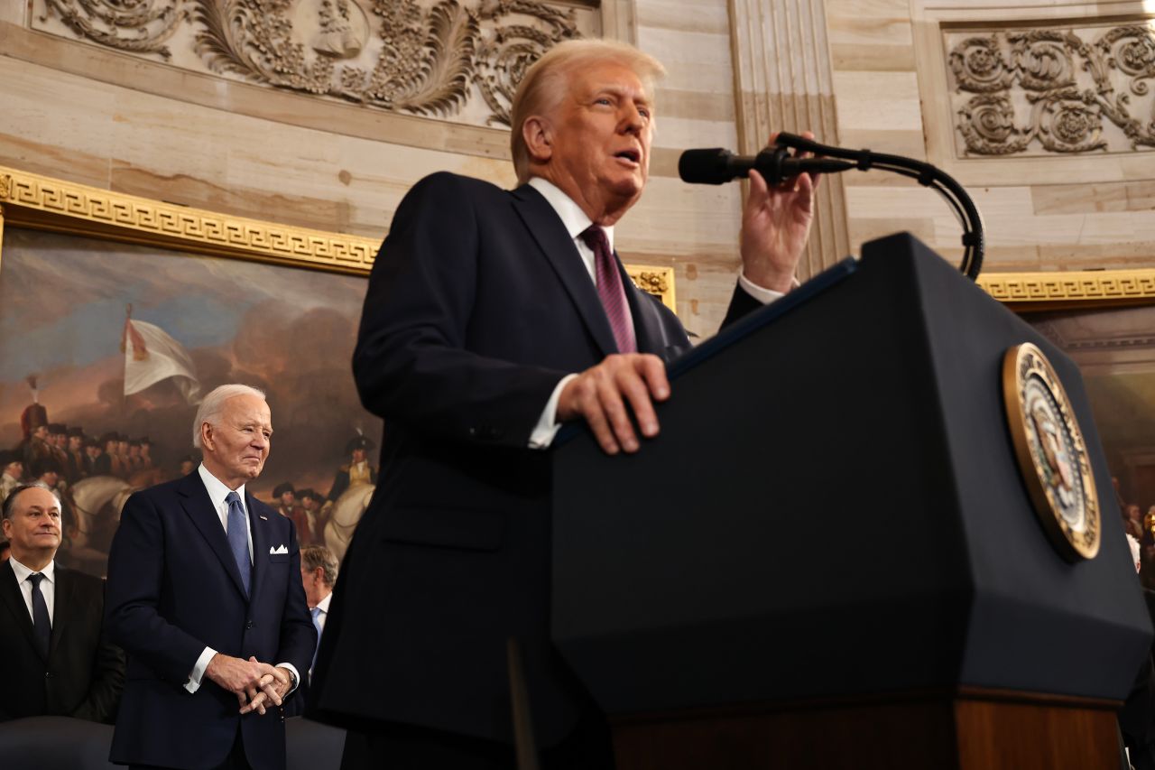 Former President Joe Biden looks on as President Donald Trump delivers his inaugural address on Monday.