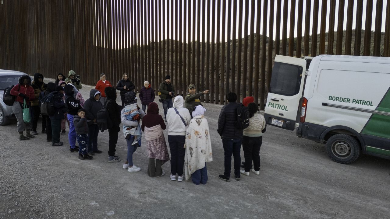 SASABE, ARIZONA - JANUARY 20: Immigrants wait to be transported by U.S. Border Patrol agents after crossing the U.S.-Mexico border on January 20, 2025 near Sasabe, Arizona. Immigrant families had ed through a gap in the Trump-built border wall hours before Donald J. Trump was inaugurated for a second time as President of the United States. (Photo by John Moore/Getty Images)