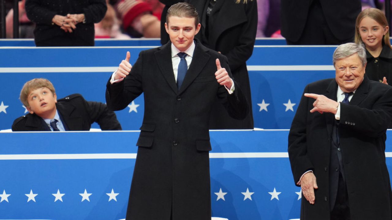 WASHINGTON, DC - JANUARY 20: Baron Trump (L) and Viktor Knavs attend an indoor inauguration parade at Capital One Arena on January 20, 2025 in Washington, DC. Donald Trump takes office for his second term as the 47th president of the United States. (Photo by Christopher Furlong/Getty Images)