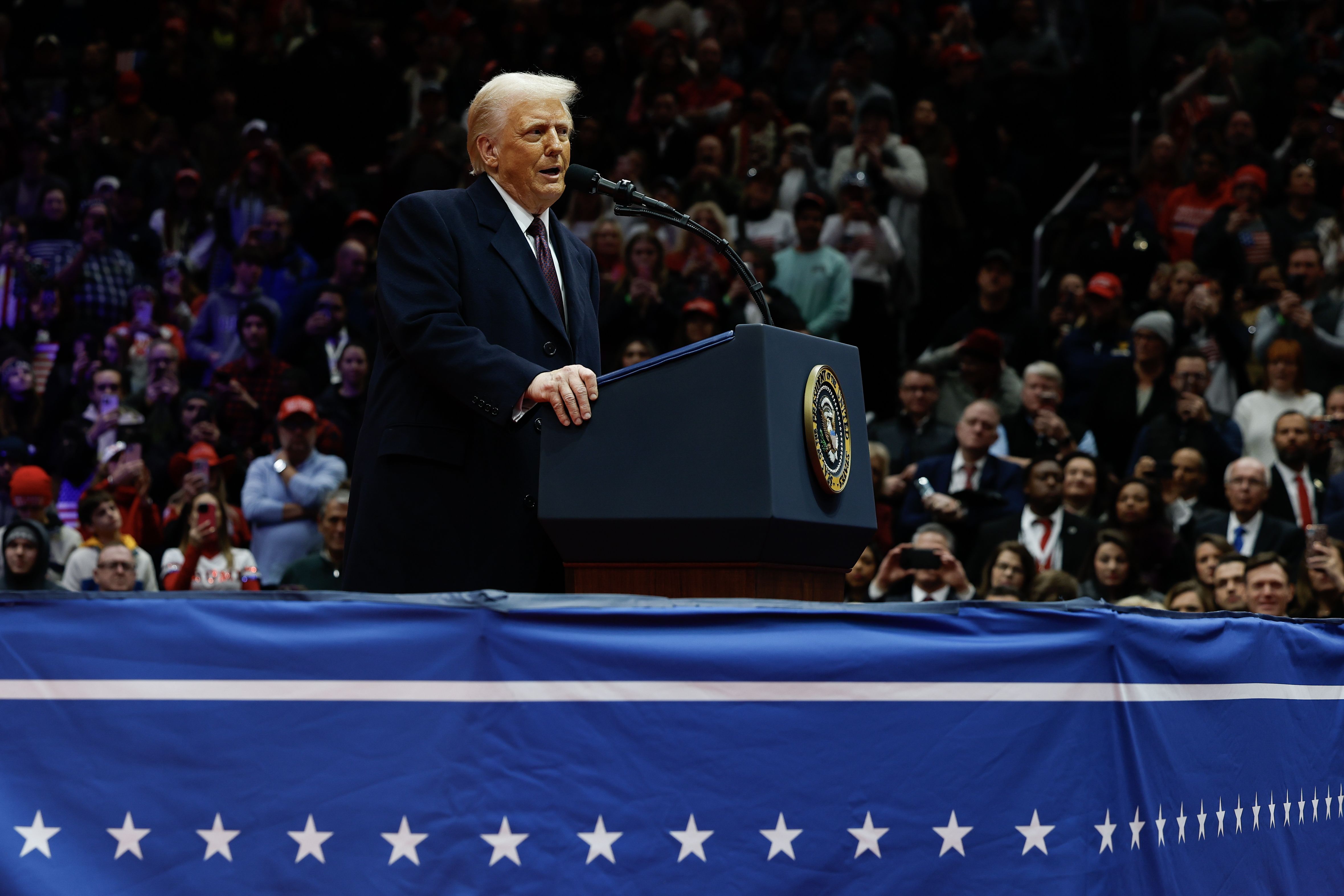 Trump speaks during the parade inside Capital One Arena on Monday.