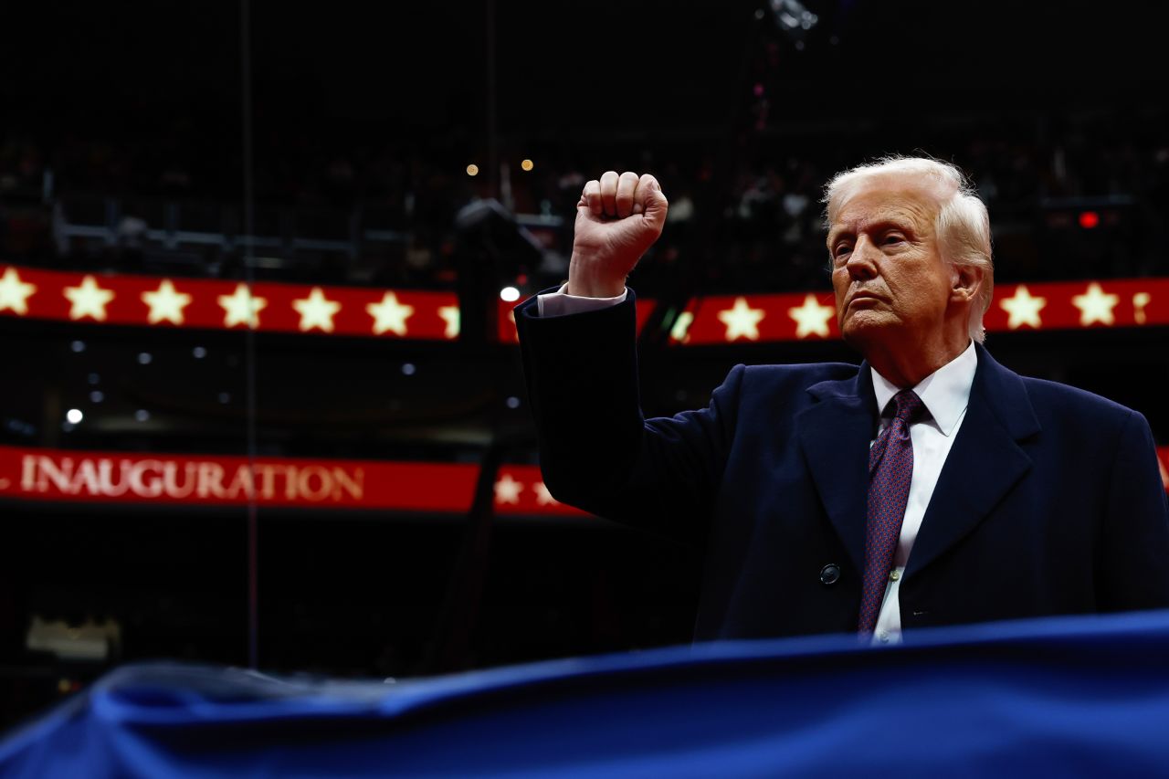 US President Donald Trump gestures to the crowd during an indoor inauguration parade at Capital One Arena on Monday.