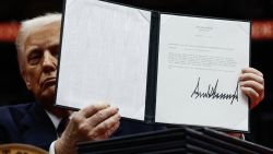 WASHINGTON, DC - JANUARY 20: U.S. President Donald Trump holds up an executive order after signing it during an indoor inauguration parade at Capital One Arena on January 20, 2025 in Washington, DC. Donald Trump takes office for his second term as the 47th president of the United States. (Photo by Anna Moneymaker/Getty Images)