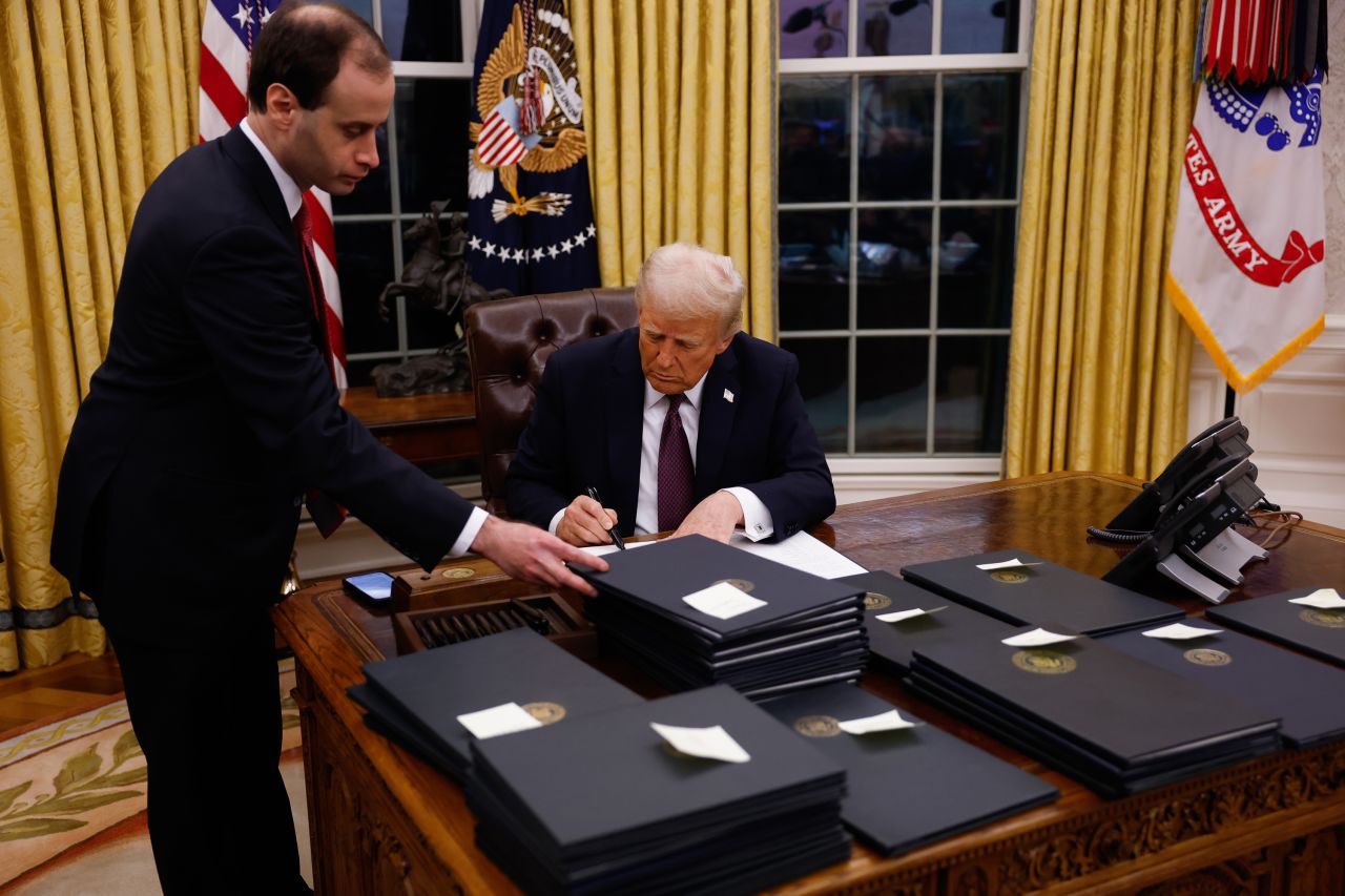 President Donald Trump signs executive orders in the Oval Office on Monday.