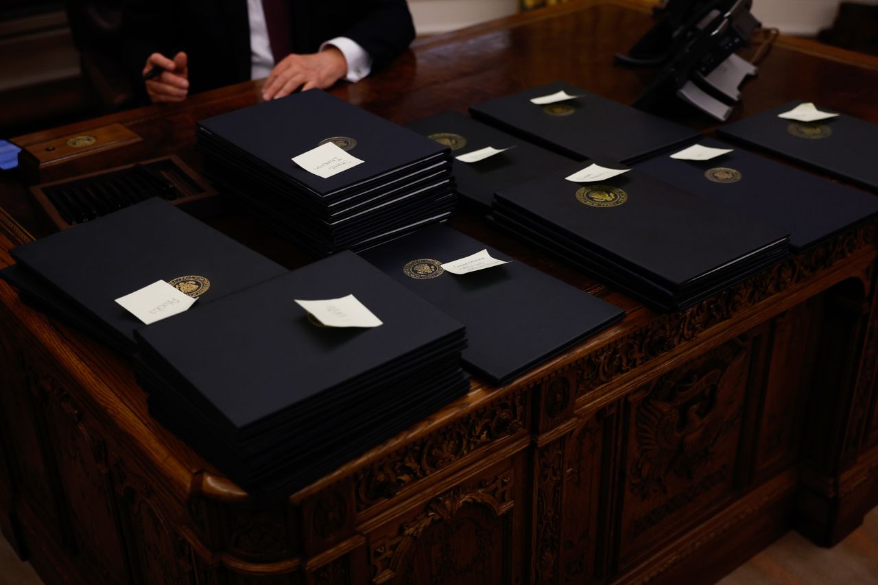 President Donald Trump signs executive orders in the Oval Office.