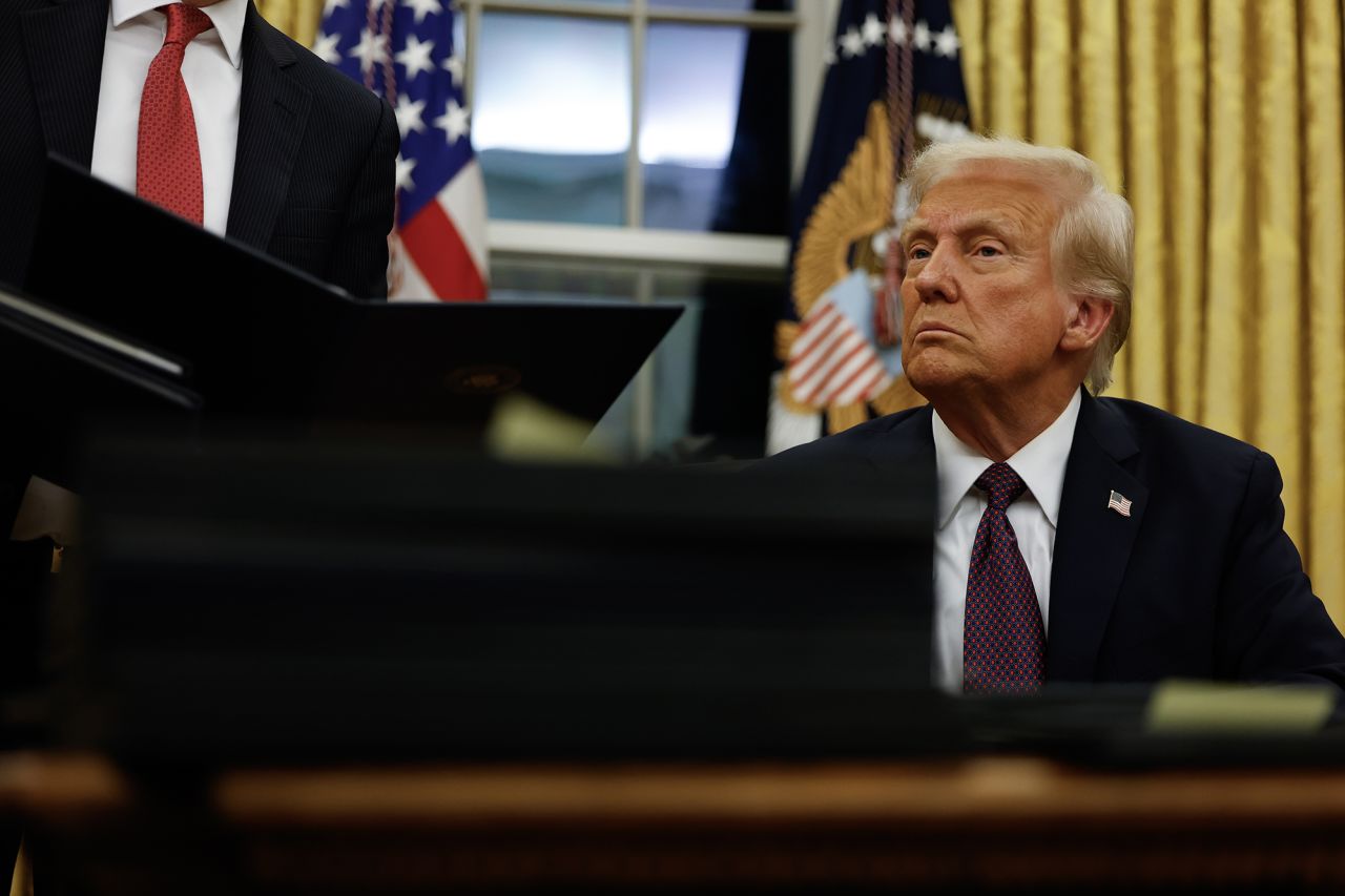 President Donald Trump signs executive orders in the Oval Office on Monday.