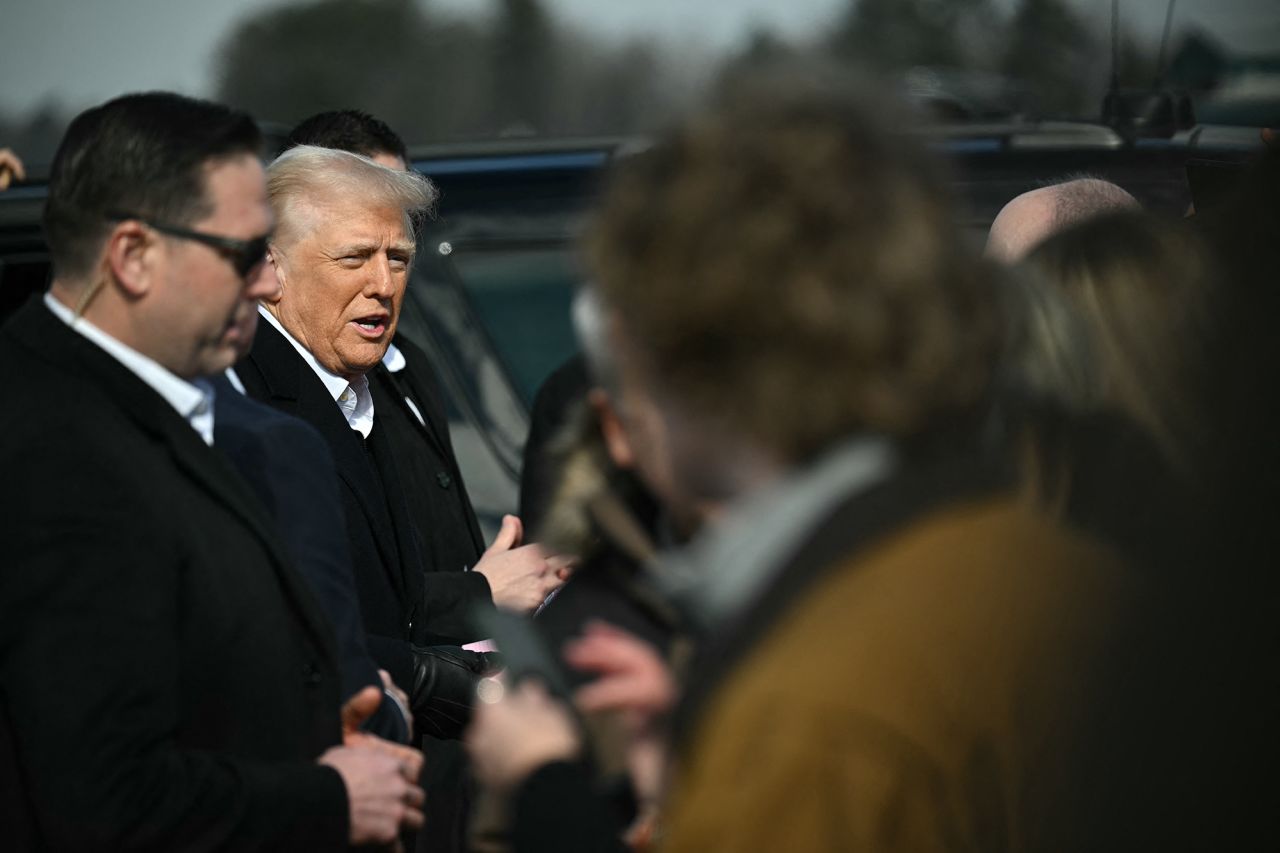 US President Donald Trump greets supporters upon arrival today at Asheville Regional Airport in Fletcher, North Carolina, to visit the region devastated by Hurricane Helene.