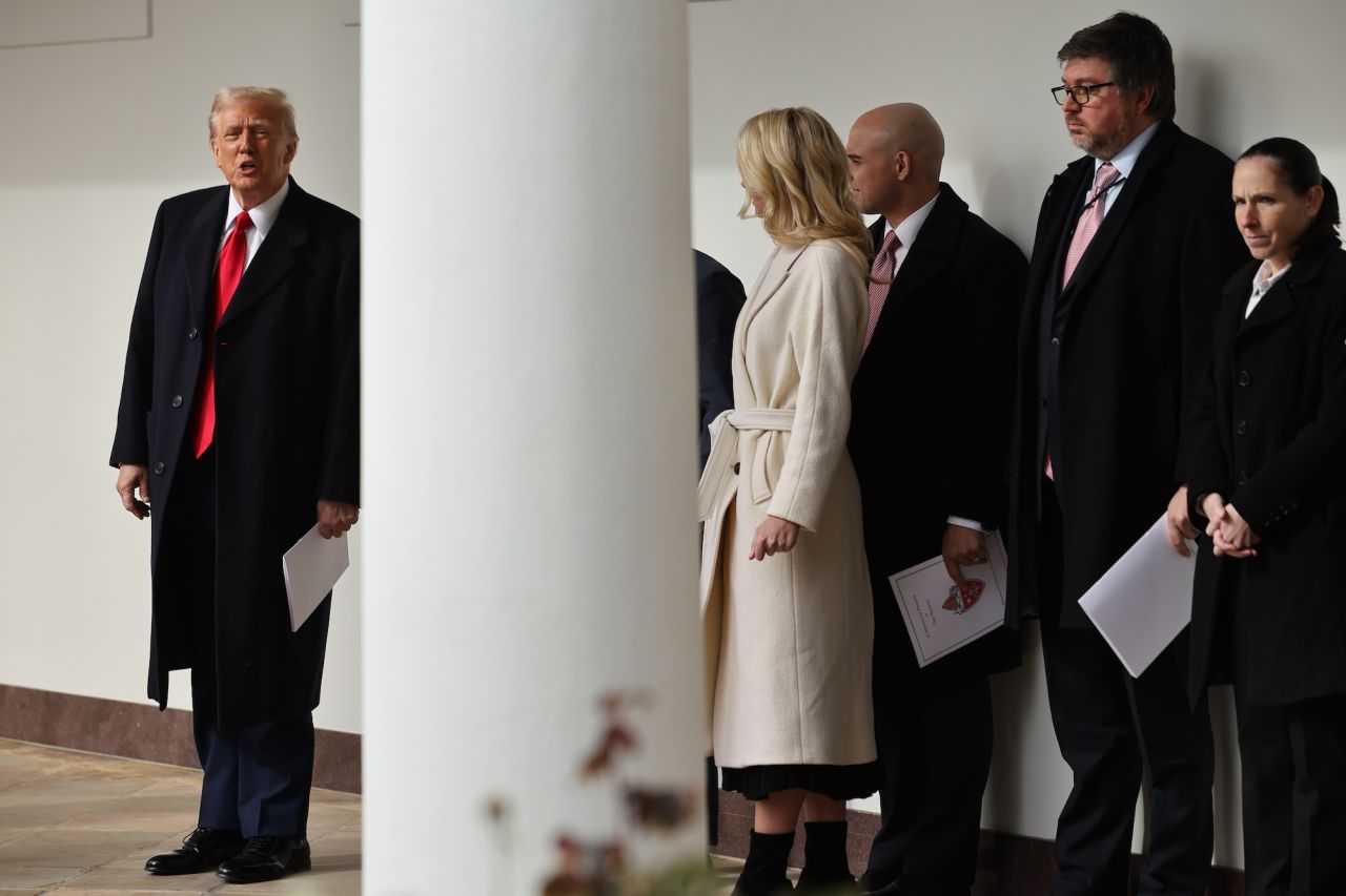 President Donald Trump speaks briefly with reporters after returning to the White House on Tuesday.