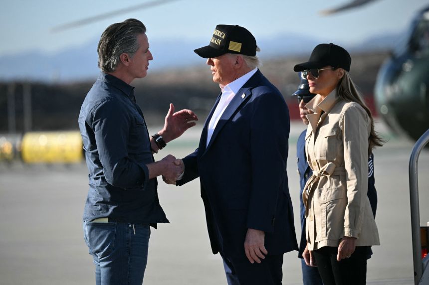 President Donald Trump, followed by first lady Melania Trump, shakes hands with California Gov. Gavin Newsom upon arrival at Los Angeles International Airport on January 24, 2025, to visit the region devastated by the Palisades and Eaton fires.