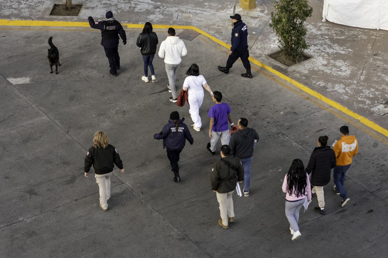 In this air view, Mexican immigration officials and police escort deportees were returned to Mexico on Wednesday, as shown in Nogales, Arizona.