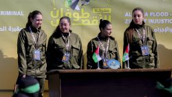 Four Israeli hostages, (L-R) Naama Levy, Liri Albag, Daniella Gilboa and Karina Ariev, wave from a stage before Hamas fighters hand them over to a team from the Red Cross in Gaza City on January 25, 2025. Hamas militants handed over four Israeli women hostages to the Red Cross in a January 25 swap after parading them on a stage at a square in Gaza, an AFP journalist reported. (Photo by Abood Abusalama / Middle East Images / Middle East Images via AFP) (Photo by ABOOD ABUSALAMA/Middle East Images/AFP via Getty Images)