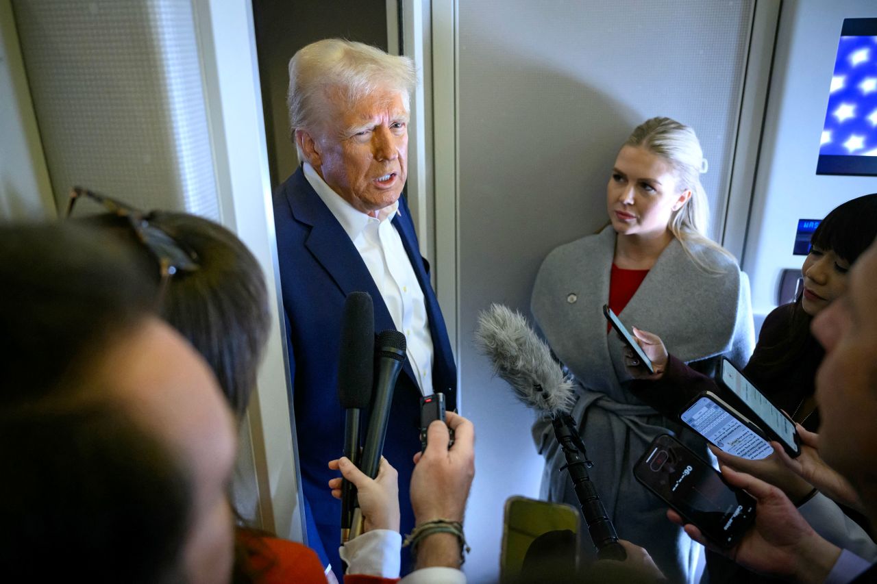 President Donald Trump speaks with the reporters alongside White House Press Secretary Karoline Leavitt, right, on board Air Force One after departing Las Vegas en route to Miami on Saturday.