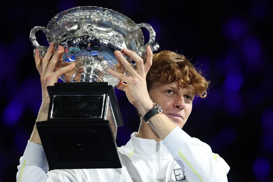 Italy's Jannik Sinner celebrates with the Norman Brookes Challenge Cup trophy after defeating Germany's Alexander Zverev during their men's singles final match on day fifteen of the Australian Open tennis tournament in Melbourne on January 26, 2025.