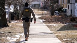 A US Immigration and Customs Enforcement (ICE) agent walks down a street during a multi-agency targeted enforcement operation in Chicago, Illinois, US, on Sunday, Jan. 26, 2025. President Donald Trump has pledged to carry out the largest deportation effort in US history, vowing to ultimately deport all of the foreigners living in the country without permission. Photographer: Christopher Dilts/Bloomberg via Getty Images