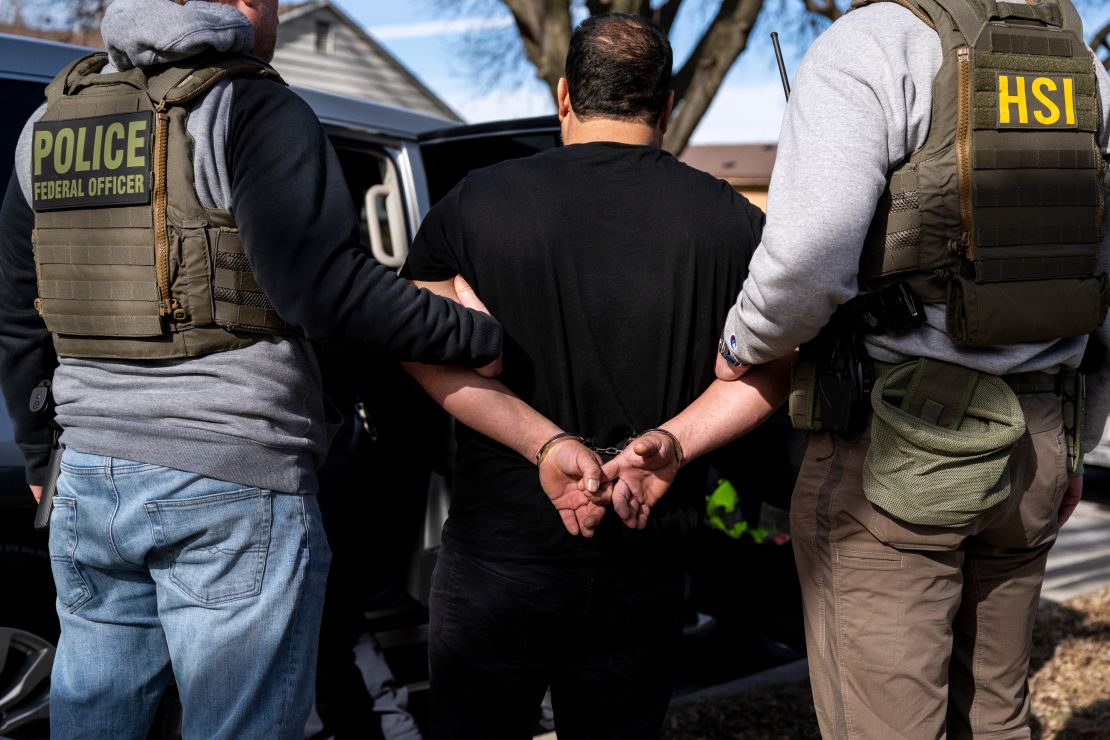 US Immigration and Customs Enforcement agents detain a suspect in Lyons, Illinois, on January 26.