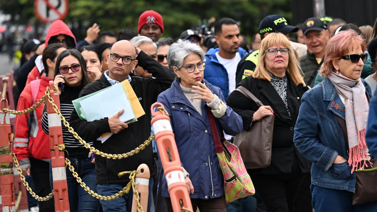 People wait outside the US embassy after their visa appointments were cancelled in Bogota on January 27, 2025. US Secretary of State Marco Rubio, whose wife is Colombian-American, suspended issuance of visas at the US embassy in Bogota and said visas would be revoked to Colombian government officials and their immediate family . The White House said the visa measures would stay in place until the first planeload of deportees returns to Colombia. (Photo by Raul ARBOLEDA / AFP) (Photo by RAUL ARBOLEDA/AFP via Getty Images)