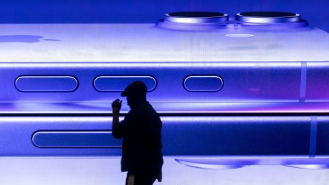 A man walks past an advertisement for an Apple iPhone at an Apple Inc. store in central London, on January 27, 2025.