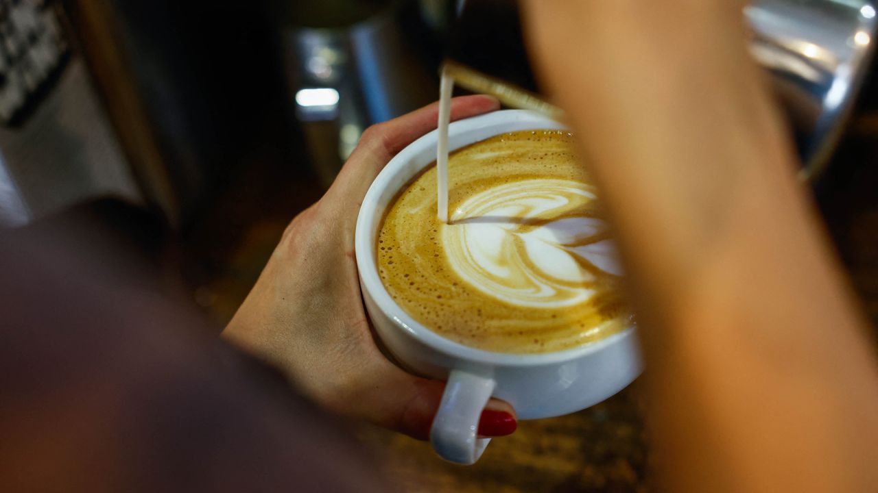 A worker prepares a coffee in New York.