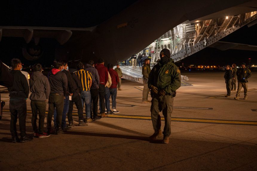 Deportees board a C-17 Globemaster III at the Tucson International Airport in Arizona in January.