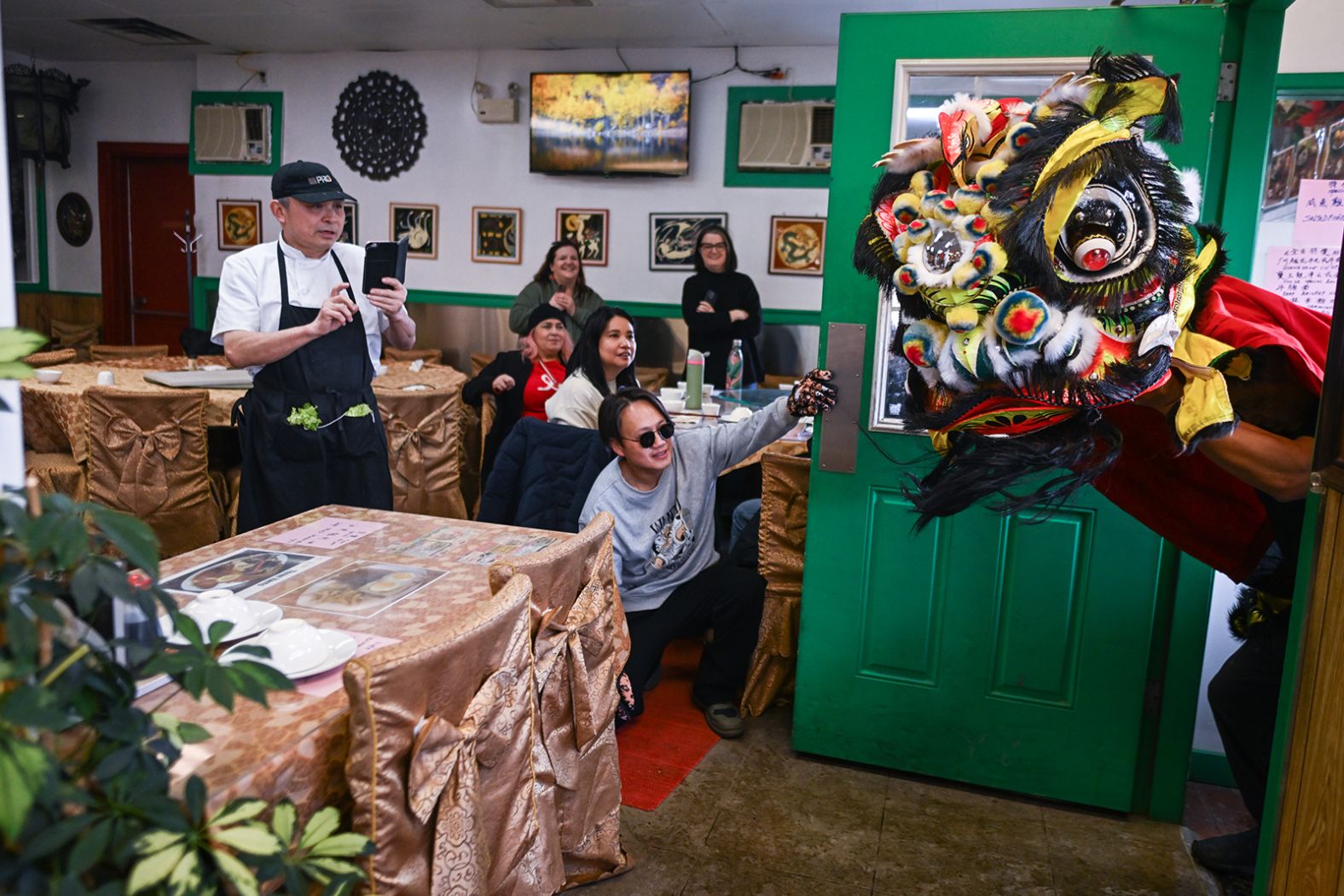A Lion Dance performs a blessing at a restaurant in the vibrant Chinatown of Edmonton, Canada, on Sunday, January 26.