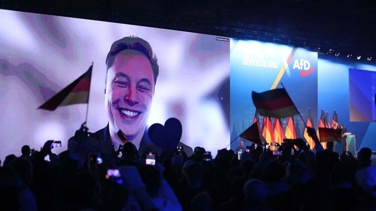 HALLE, GERMANY - JANUARY 25: Tech billionaire Elon Musk speaks live via a video transmission during a speech by Alice Weidel, chancellor candidate of the far-right Alternative for Germany (AfD) political party, at the AfD election campaign launch rally on January 25, 2025 in Halle, Germany. Musk is an outspoken supporter of the AfD and is urging German voters to cast their ballots for the party. The AfD is currently in second place in polls ahead of federal parliamentary snap elections scheduled for February 23. (Photo by Sean Gallup/Getty Images)