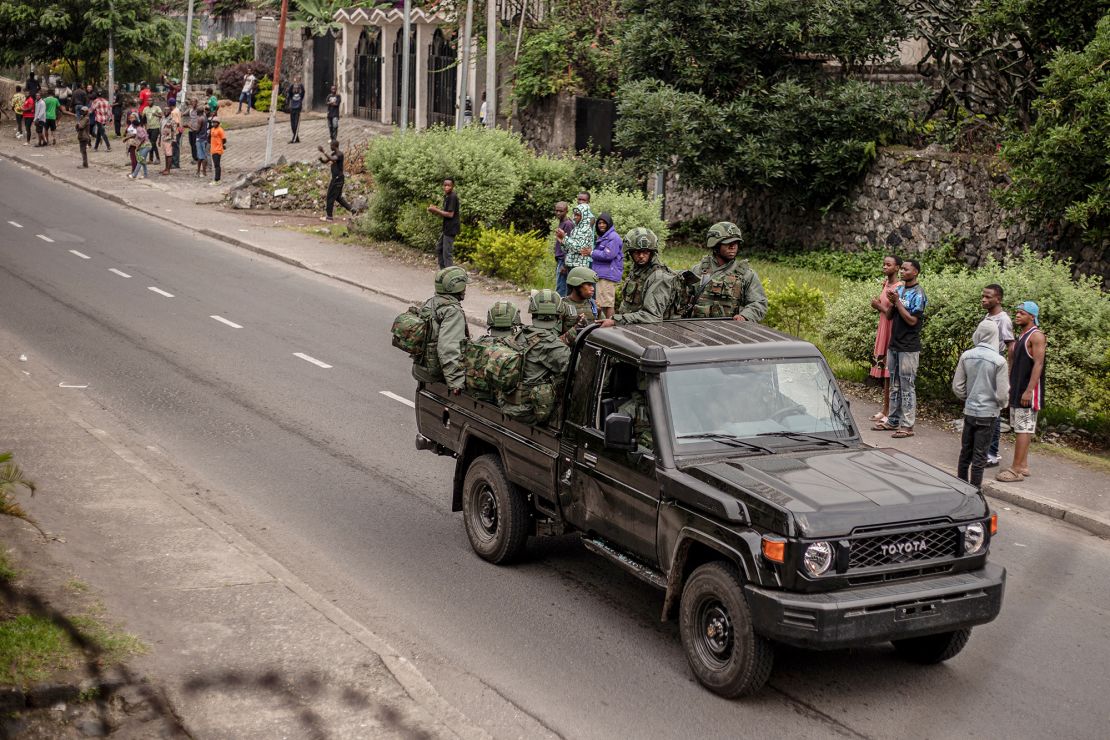 Members of the M23 armed group travel in a pickup truck on Goma street on Wednesday.