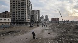 Displaced Palestinians pass destroyed buildings as they return to the north from the southern Gaza Strip via the Al Rachid road, during the ceasefire, in Gaza City, Gaza, on Tuesday, Jan. 28, 2025. Tens of thousands of Palestinians are travelling back to the devastated neighborhoods of northern Gaza after being displaced during the Israel-Hamas war, as a fragile 42-day ceasefire moves into a second week. Photographer: Ahmad Salem/Bloomberg via Getty Images