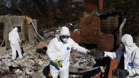 ALTADENA, CALIFORNIA - JANUARY 25: Nick Sonnenburg (C) and his parents search for personal items to recover from the remains of his apartment which burned in the Eaton Fire on January 25, 2025 in Altadena, California. President Donald Trump surveyed wildfire damage yesterday and pledged to 'open the coffers' for federal aid to California. Multiple wildfires fueled by intense Santa Ana Winds burned across Los Angeles County leaving at least 28 dead with over 180,000 people having been under evacuation orders. Over 12,000 structures, many of them homes and businesses, burned in the Palisades and Eaton Fires.  (Photo by Mario Tama/Getty Images)