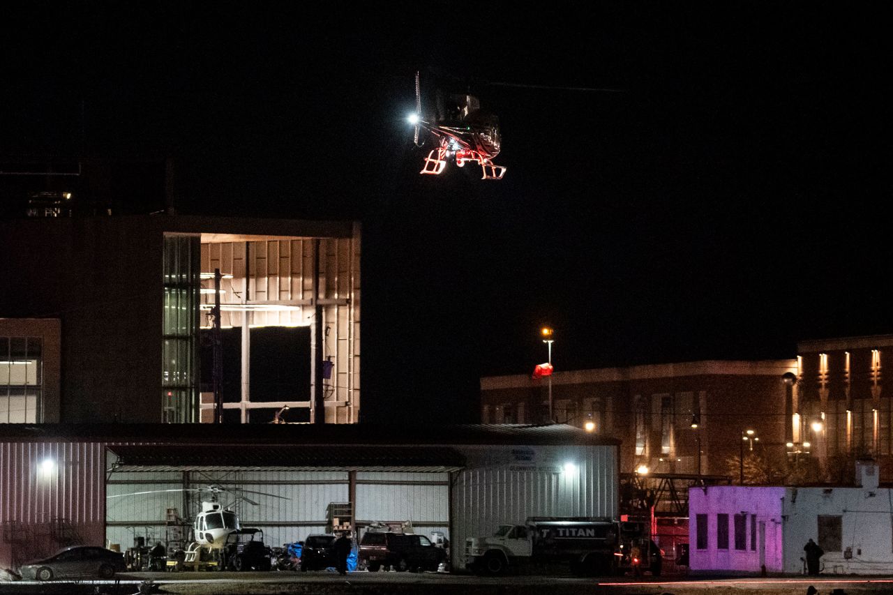 A helicopter aids in search operations in the Potomac River, near Ronald Reagan Washington Airport, on Wednesday