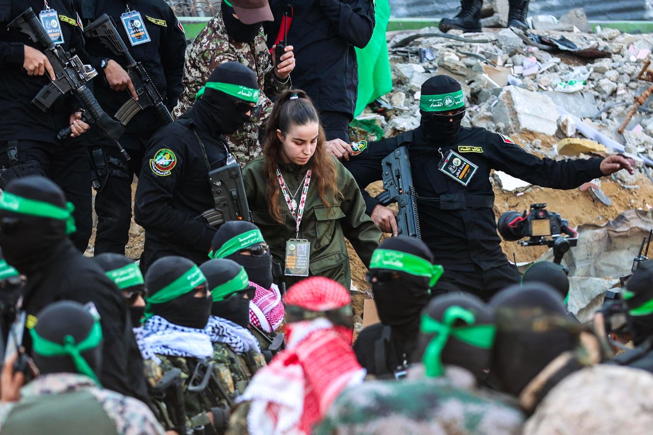 Hamas militants escort Israeli hostage Agam Berger, center, before handing her over to a Red Cross team in Jabalya, Gaza, on Thursday.