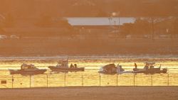 Part of the wreckage is seen as rescue boats search the waters of the Potomac River after a plane on approach to Reagan National Airport crashed into the river outside Washington, DC, on January 30, 2025. A regional jet from Kansas crashed into Washington's Potomac River after colliding mid-air with a military helicopter near Reagan National Airport, officials said January 29, prompting a major emergency response and grounding all flights. (Photo by ANDREW CABALLERO-REYNOLDS / AFP) (Photo by ANDREW CABALLERO-REYNOLDS/AFP via Getty Images)